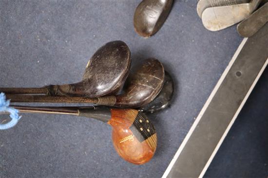 A collection of golf clubs, including woods and irons (makers including Whitcombe and Spalding)